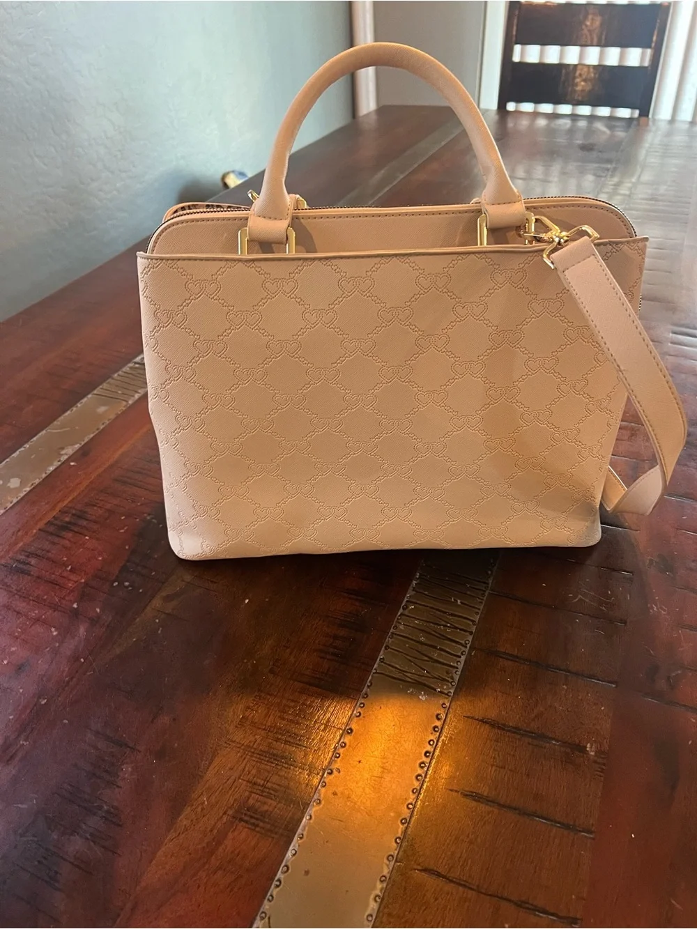 Betsey Johnson satchel handbag featuring an embossed heart pattern